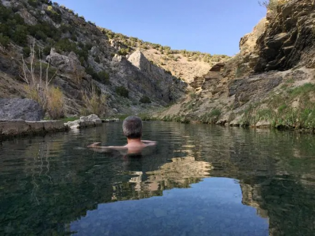 man swimming in a cove in lake mead