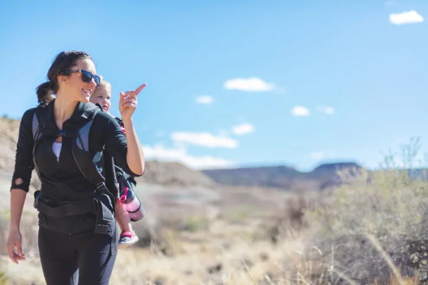 women hiking with a baby on her back