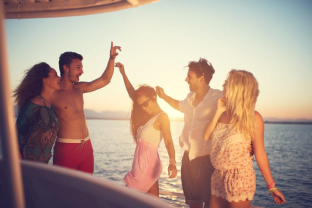 Group of people dancing on a boat