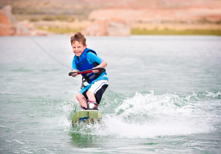Kid on a wakeboard in the water