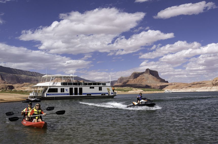 Houseboat, jet ski and kayak on the lake