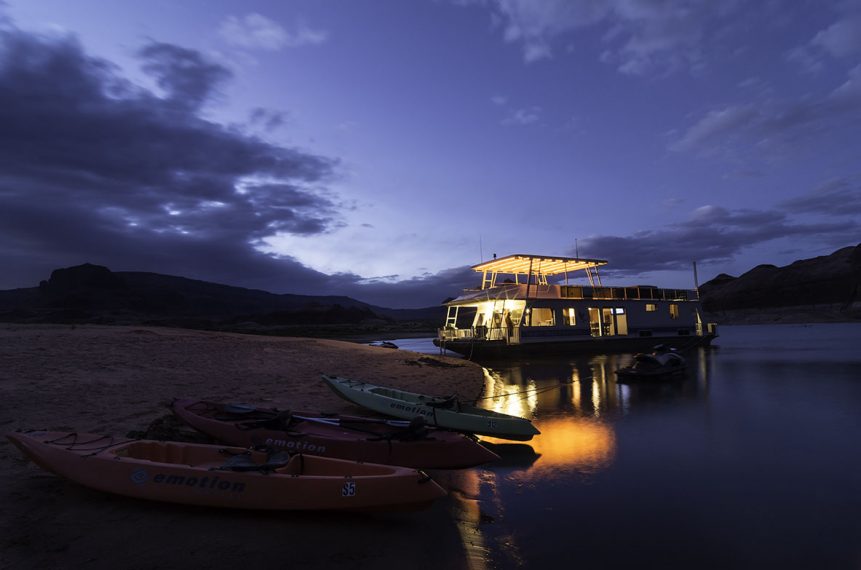 houseboat docked on a beach at night