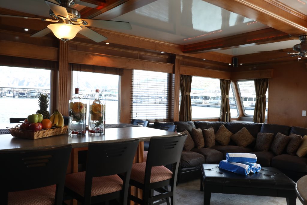 large houseboat living area with table and chairs and sofa