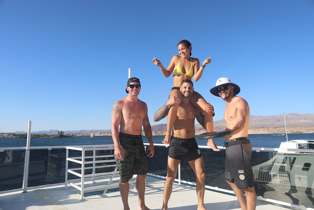 4 people on the roof of a houseboat