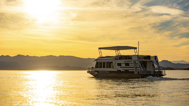 A houseboat on the lake at sunset